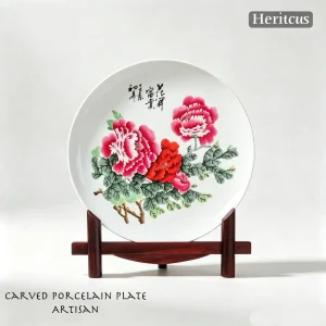 Hand-carved porcelain plate with peony design, symbol of wealth and honor, by Heritage & Craft.