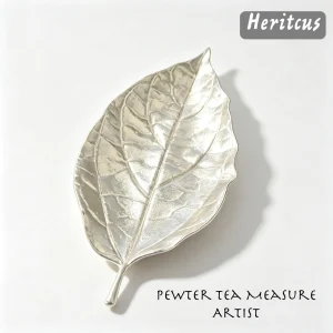 Hammered tin leaf-shaped tea scoop with handcrafted textured surface, traditional Chinese tea accessory,by Heritage & Craft.