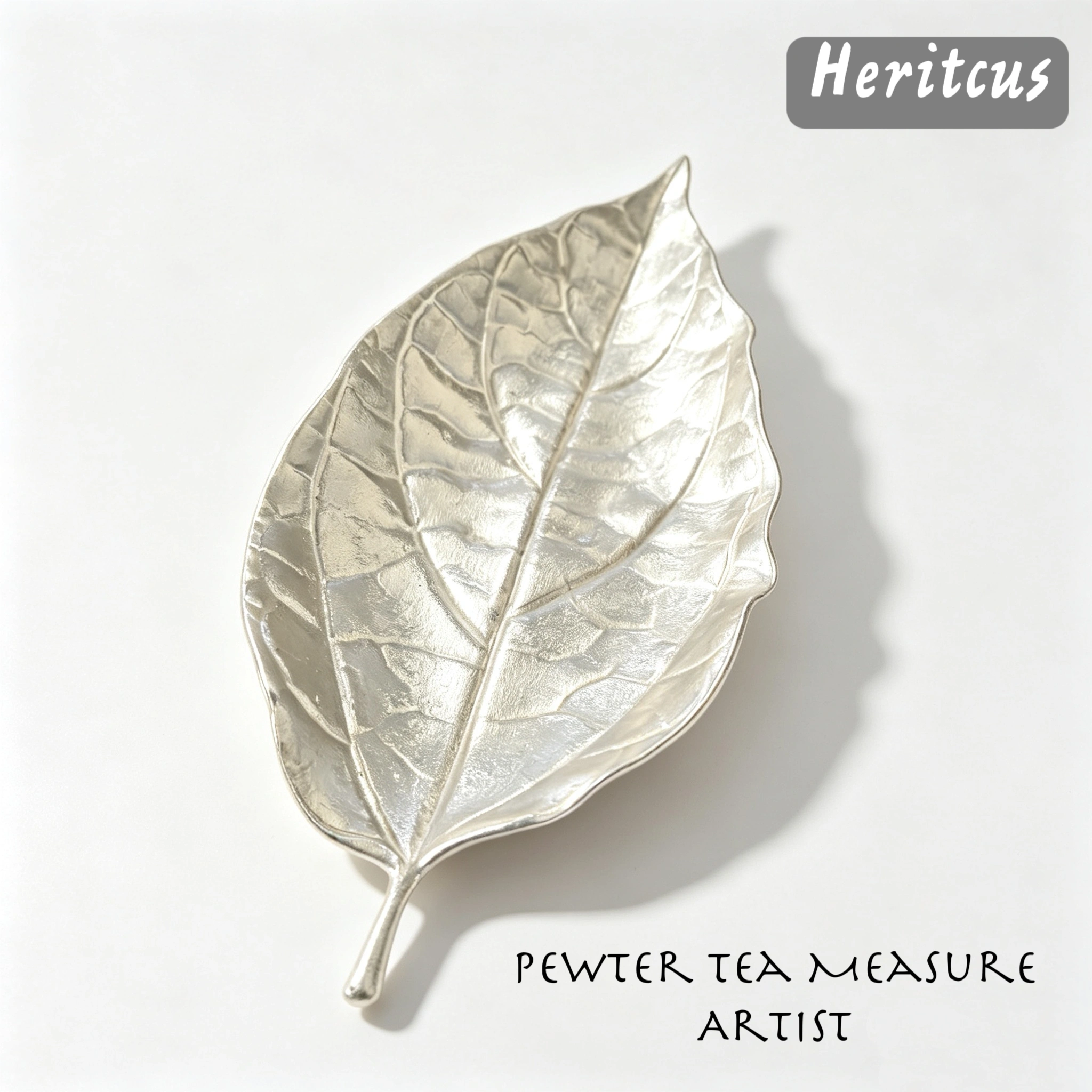 Hammered tin leaf-shaped tea scoop with handcrafted textured surface, traditional Chinese tea accessory,by Heritage & Craft.