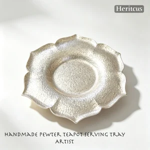 Hammered tin petal-shaped teapot stand with handcrafted textured surface, traditional Chinese tea accessory, by Heritage & Craft.