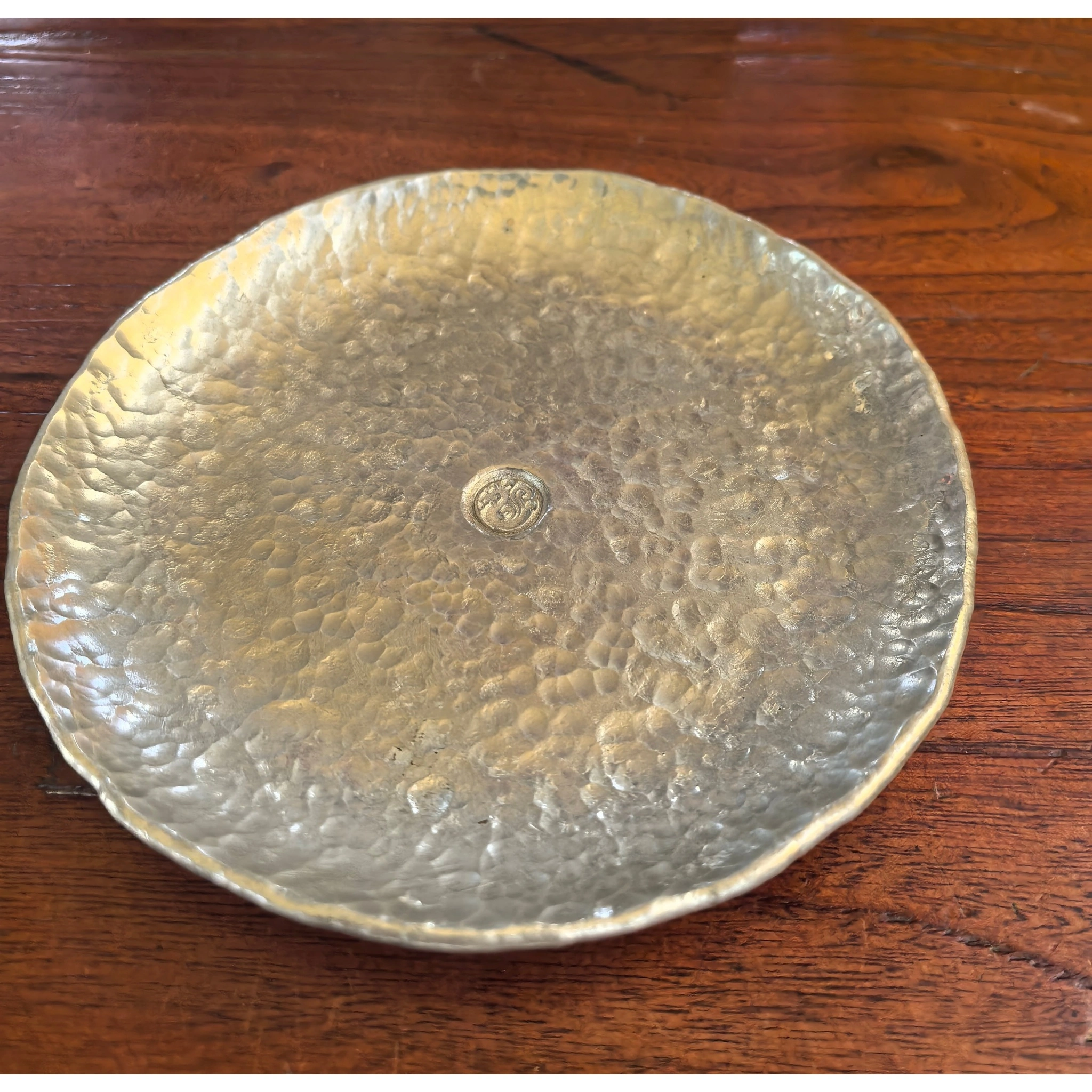 Hammered tin teacup saucer original full view, showing hand-hammered texture and metallic finish,