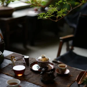 Tea ceremony setting with artisan crafted accessories on a wooden tea table