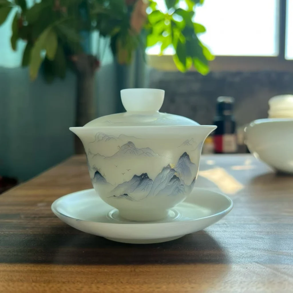 Hand-engraved Luqing celadon porcelain plate with landscape design, finished ceramic collectible, by Heritage & Craft.
