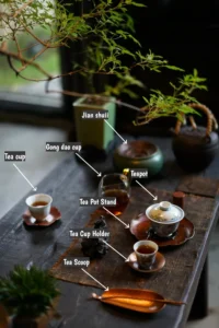A complete Chinese gongfu tea set arranged on a tea tray, featuring a clay teapot and a porcelain gaiwan as brewing vessels, a glass fairness cup for even distribution, multiple small ceramic tasting cups, a hammered copper tea boat under the teapot, a hammered copper waste water bowl (jianshui) at the side, and hammered copper cup holders beneath each drinking cup, with bamboo tea tools neatly placed nearby — all set up for a traditional tea brewing session.